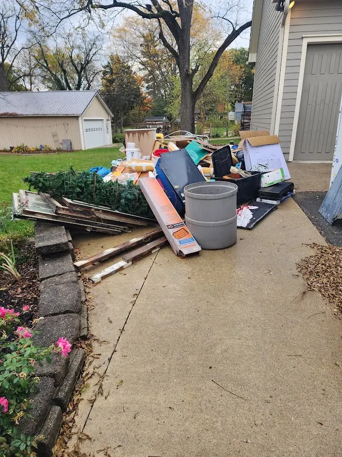 Dumpster being loaded with debris for Residential Dumpster Rental in Whiteman AFB